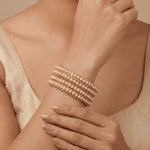 Load image into Gallery viewer, Set of 4 Gold-Plated Pearl Studded Bangles
