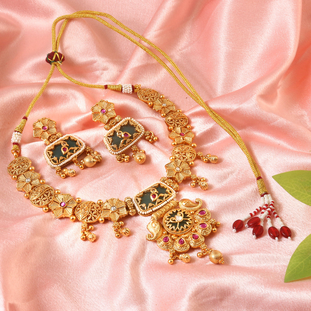South Indian gold-plated choker set with emerald, ruby accents & antique finish